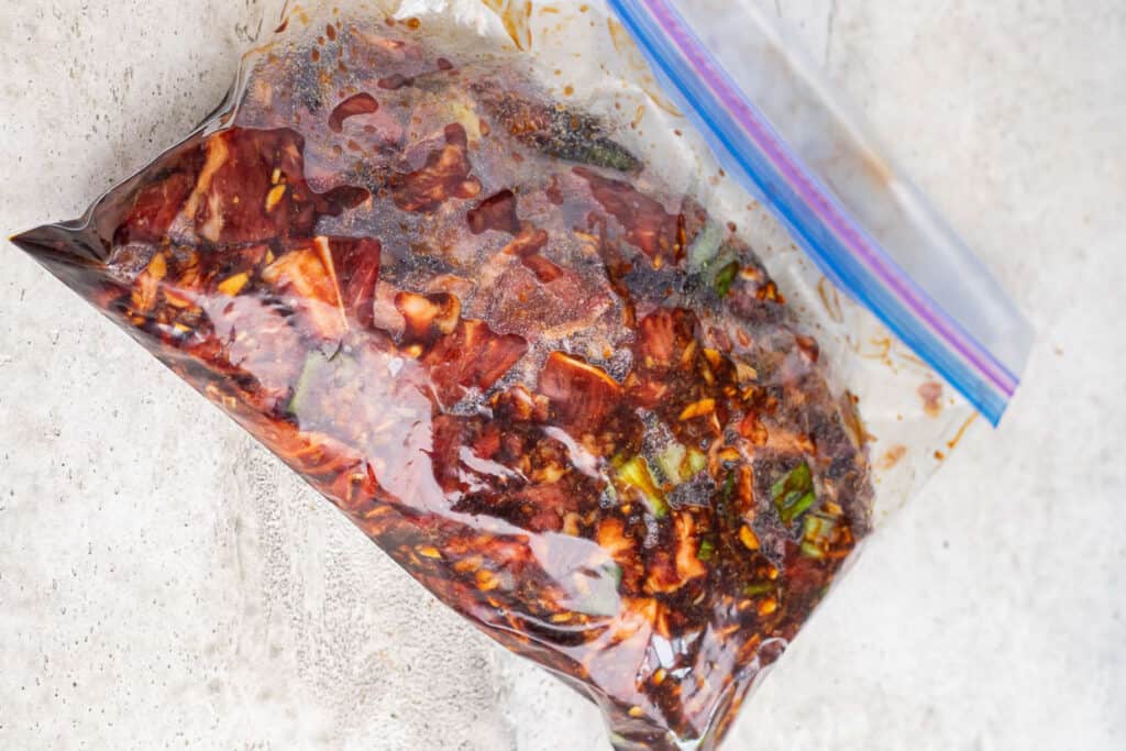 Bulgogi meat and marinade in a resealable plastic bag.
