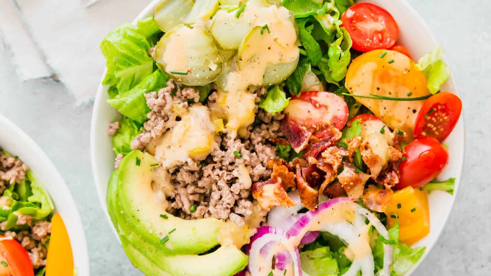 Burger bowl with bacon, lettuce, tomato, onion, avocado and special sauce.
