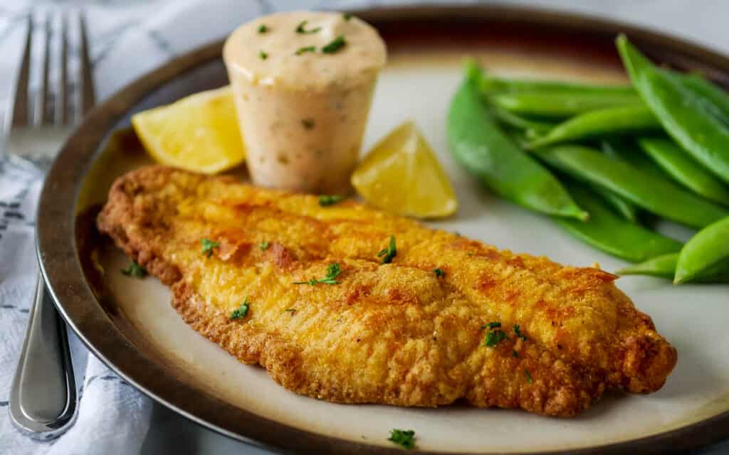 catfish fillet with cornmeal breading topped with herbs and served with spicy tartar sauce.