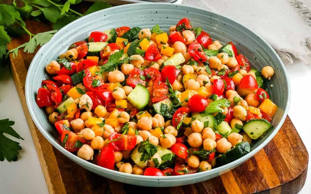 healthy chickpea salad in a blue bowl.