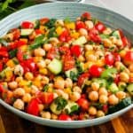 Healthy chickpea salad in a blue bowl.