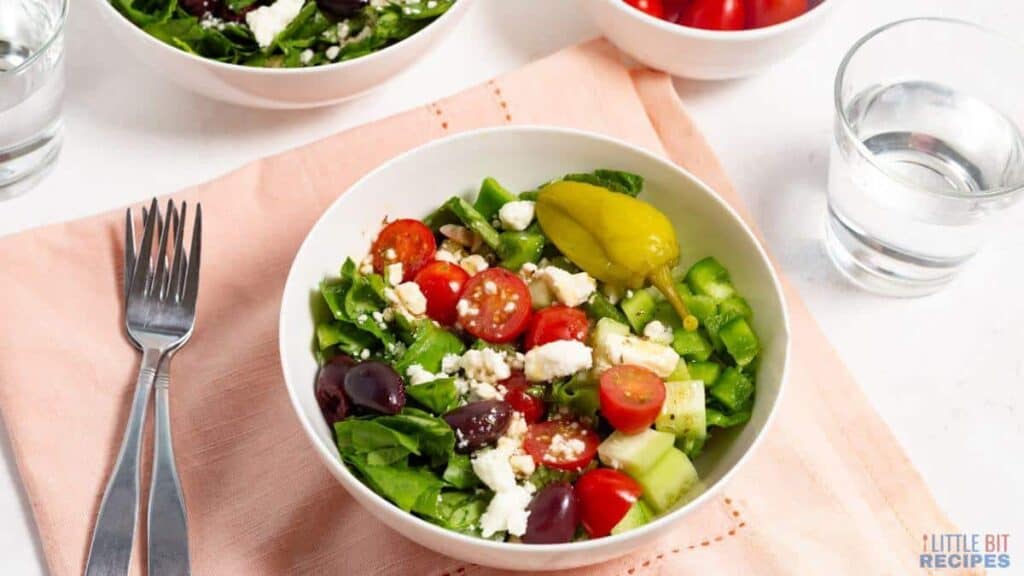 A colorful salad in a white bowl.