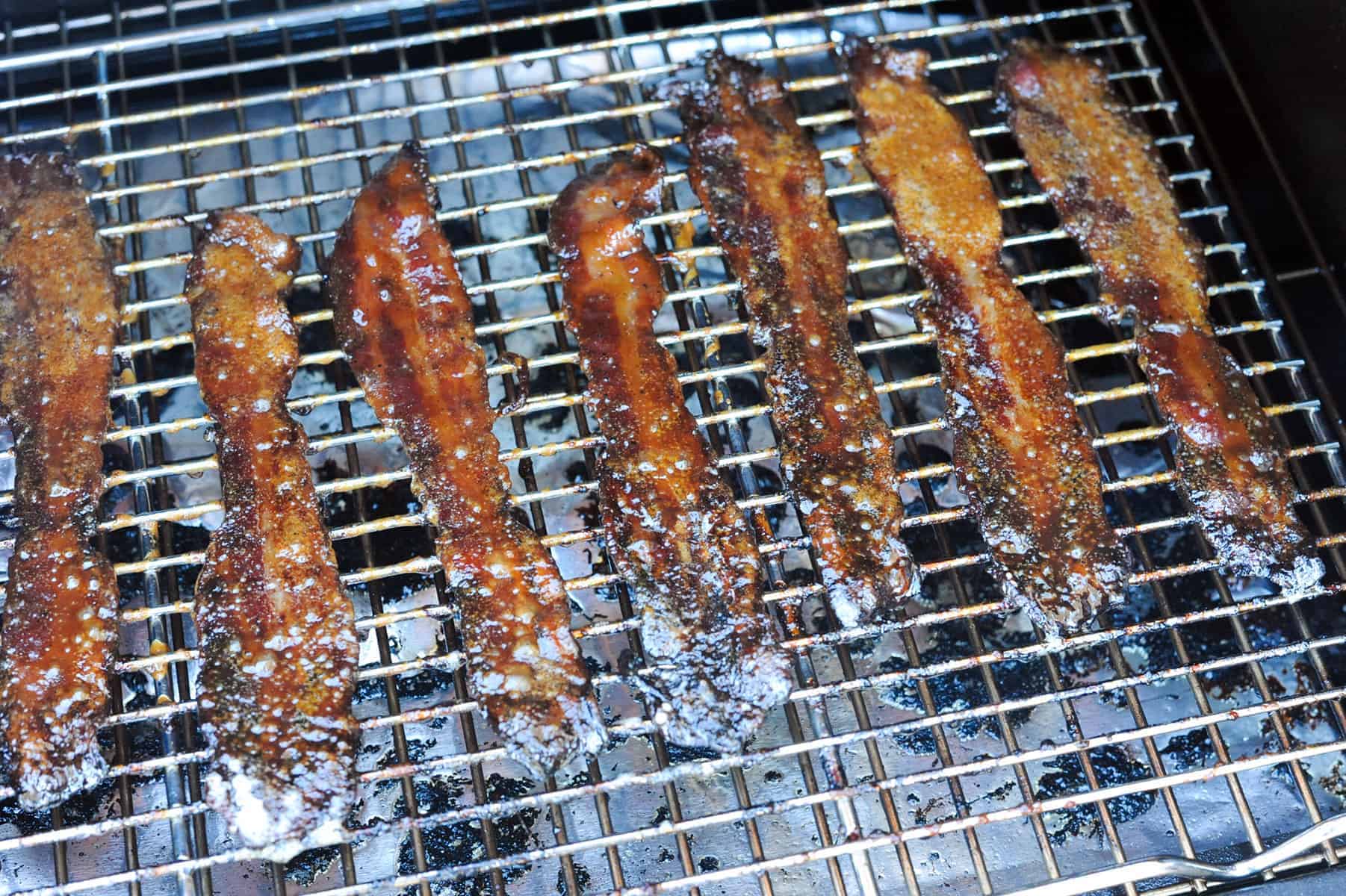 Brown Sugar Bacon on a grill. 