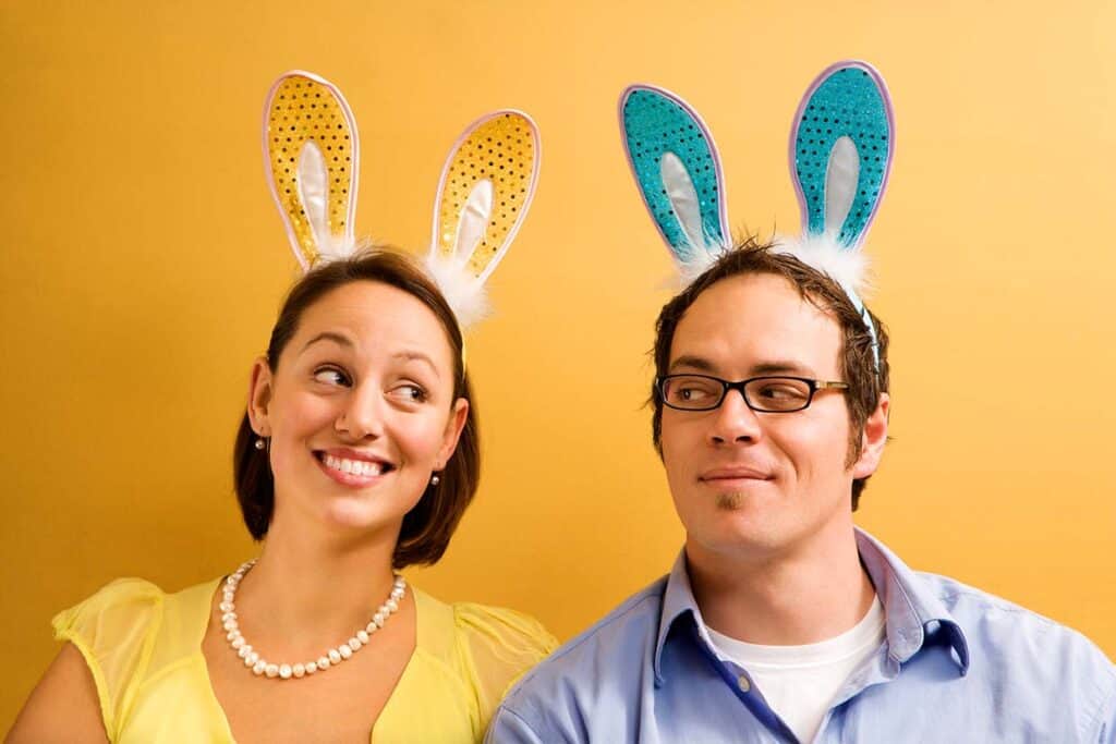 Man and woman wearing rabbit ears.