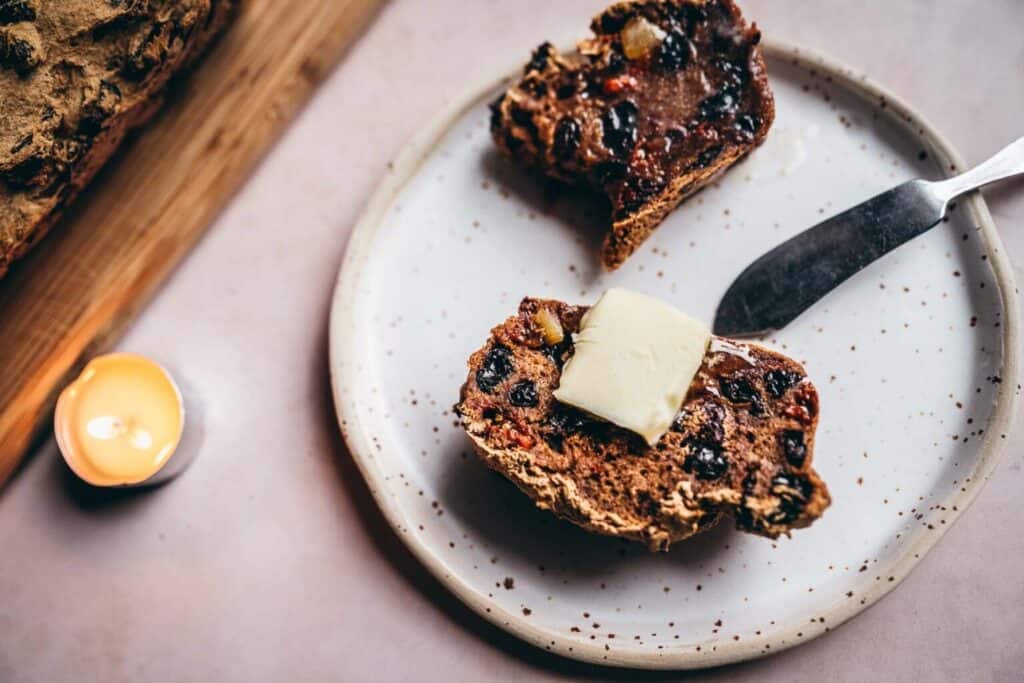 Gluten-Free Barmbrack on a plate with butter.