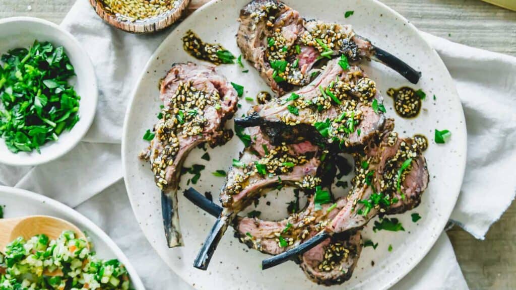 Za'atar grilled rack of lamb chops on a plate.