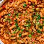 Ground beef pasta skillet garnished with parsley.