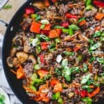 Ground beef stir fry in a skillet.