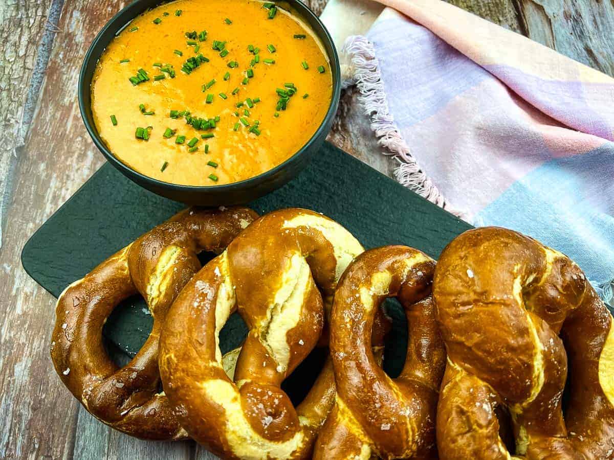 Guinness Cheese Dip on a platter with soft pretzels.