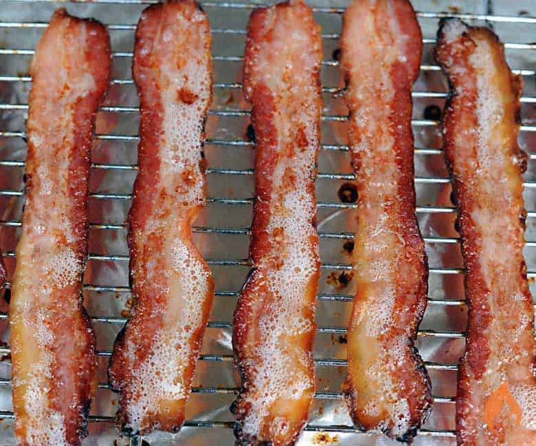 Homemade bacon on a rack. 