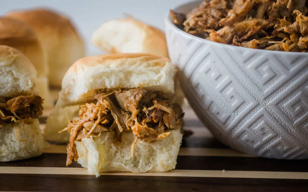 Instant pot pulled chicken sliders on a cutting board.