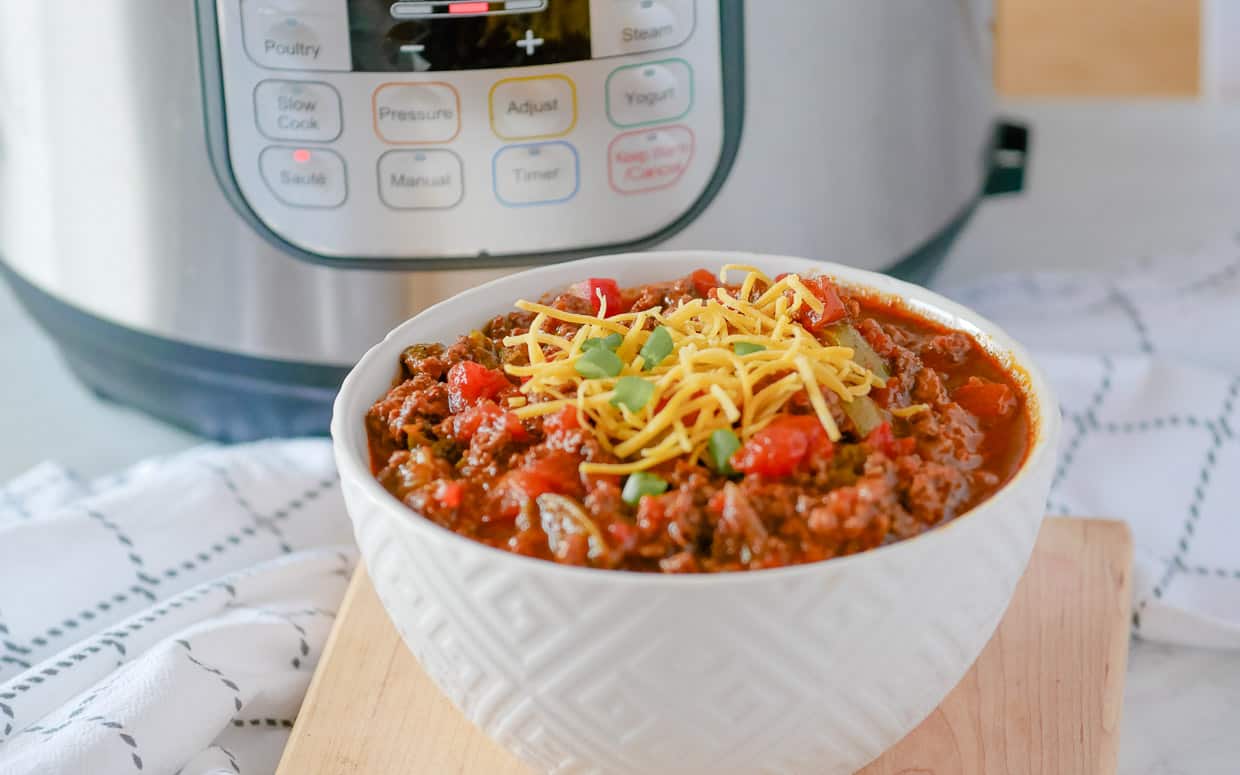 Bowl of chili in front of the Instant pot.