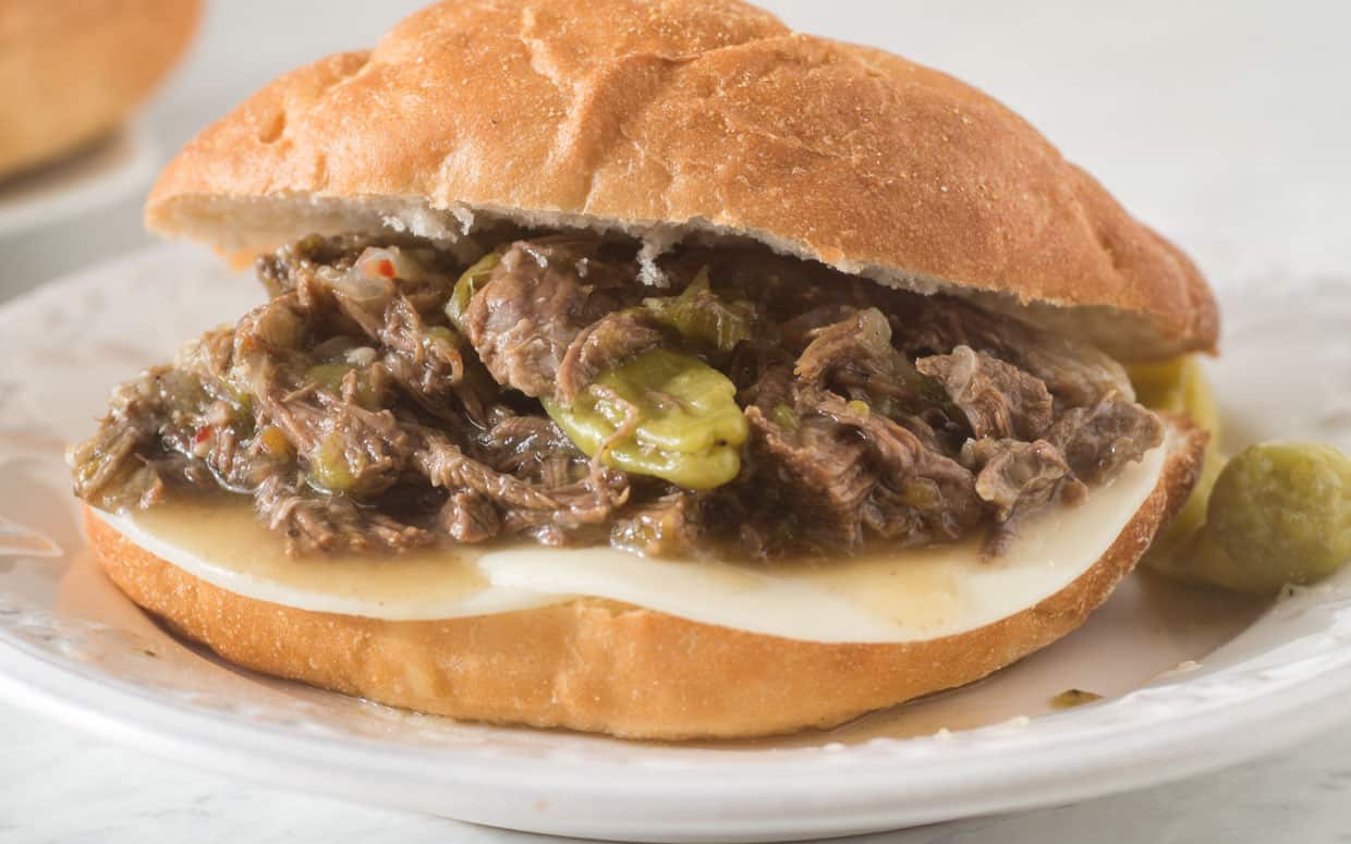Instant Pot Italian Beef on a roll with cheese.