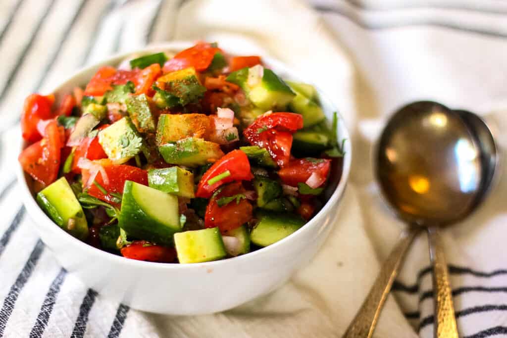 Chopped vegetables in a white ceramic bowl.