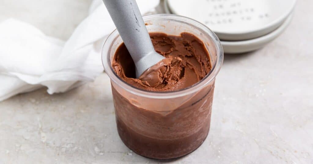 a pint of keto chocolate protein ice cream with an ice cream scoop.