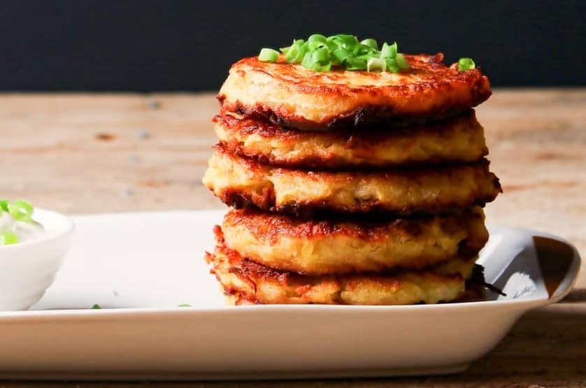 Stacked latkes on a plate.