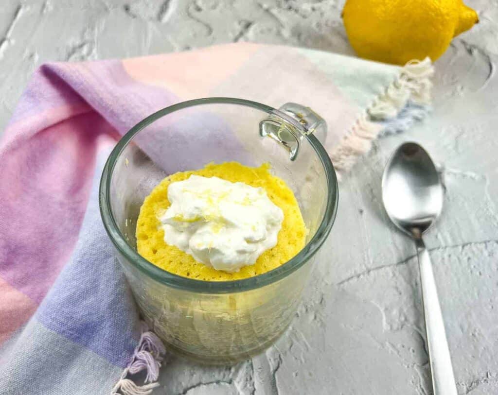 Keto lemon mug cake with whipped cream.