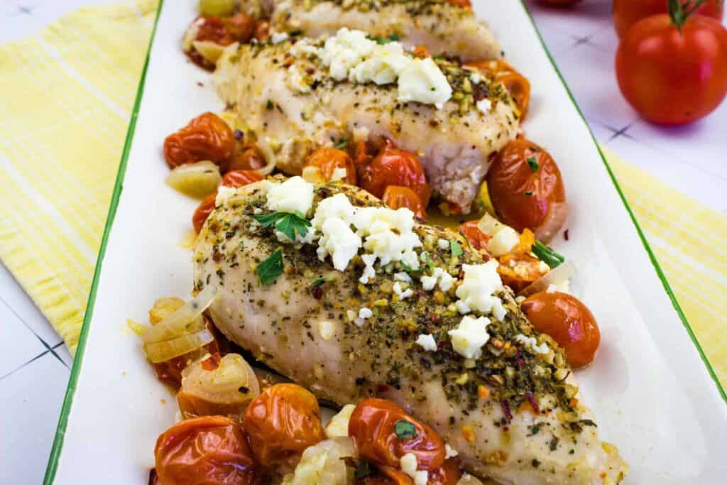 Chicken breast with herbs, cheese and tomatoes.