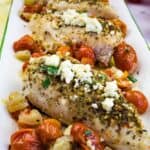 Chicken breast with herbs, cheese and tomatoes.