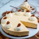 No Bake Pumpkin Cheesecake topped with whipped cream and pecans.