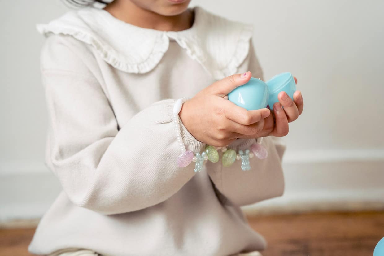 Girl opening Easter egg.