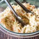 Copycat coleslaw recipe served with spoons.