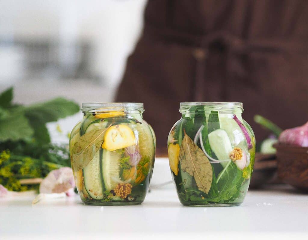 Quick pickles with spices in glass jars.