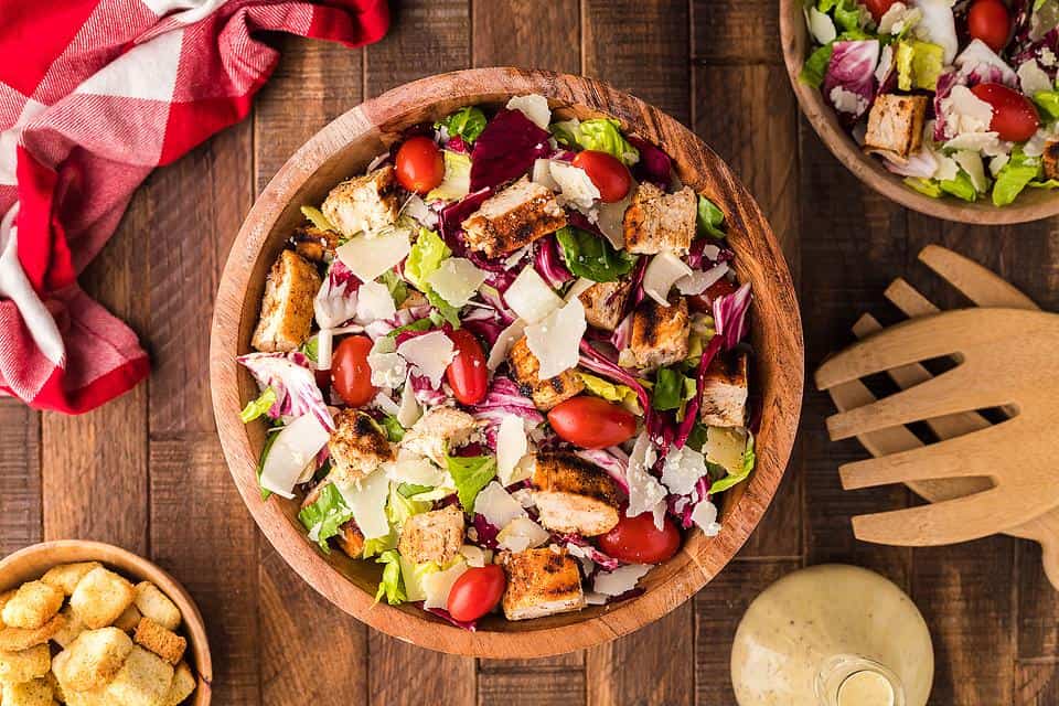 A colorful chopped salad in a wooden bowl.
