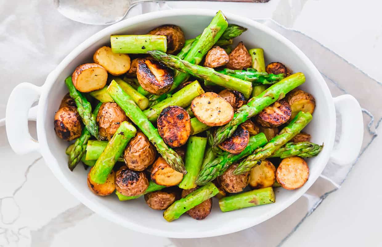 Garlic Balsamic Roasted Asparagus and Potatoes in a white baking dish.