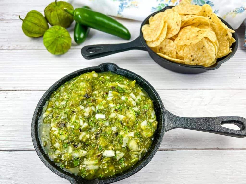 roasted tomatillo salsa in a small black cast iron skillet.