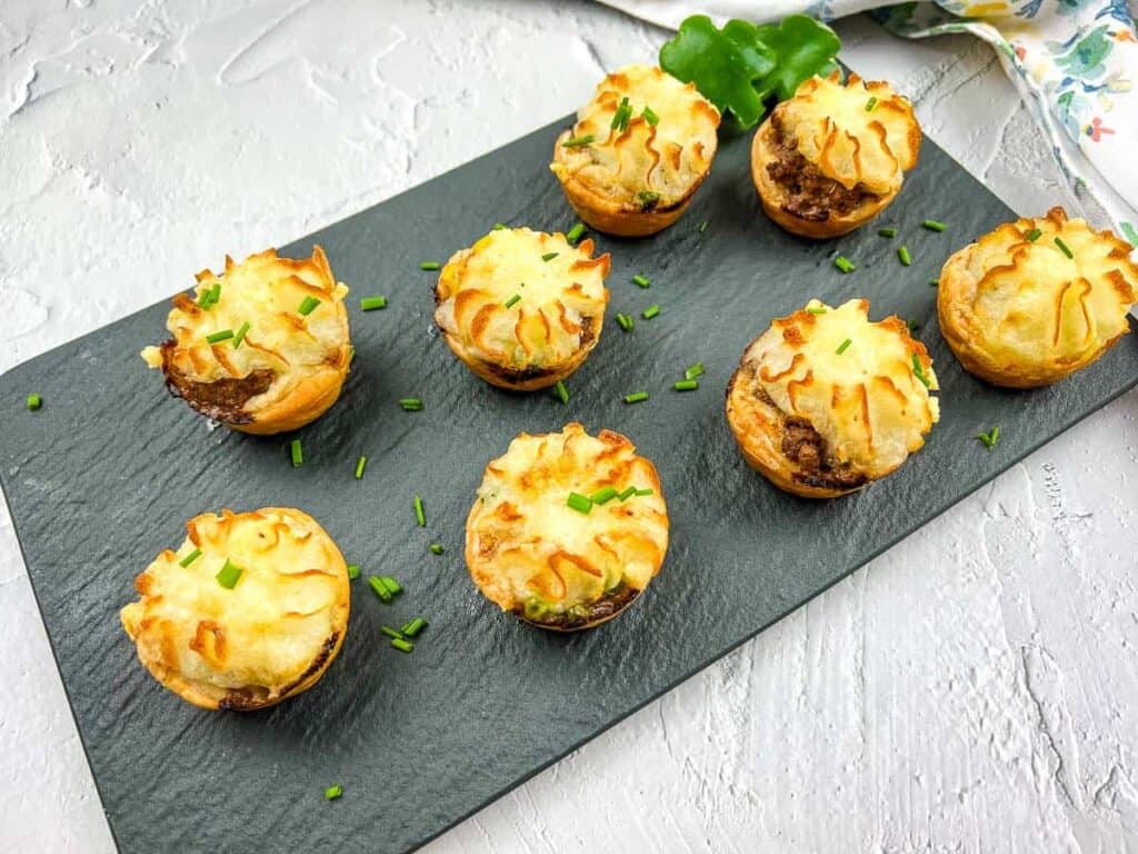 Shepherd's pie bites on slate platter.