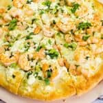 A pizza with shrimp and cheese on top.