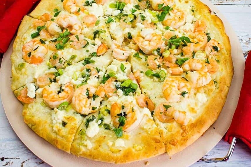 A pizza with shrimp and cheese on top.
