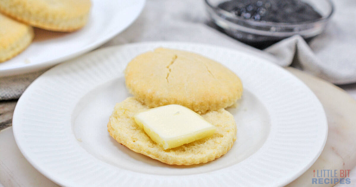 Buttermilk biscuit on plate with butter.