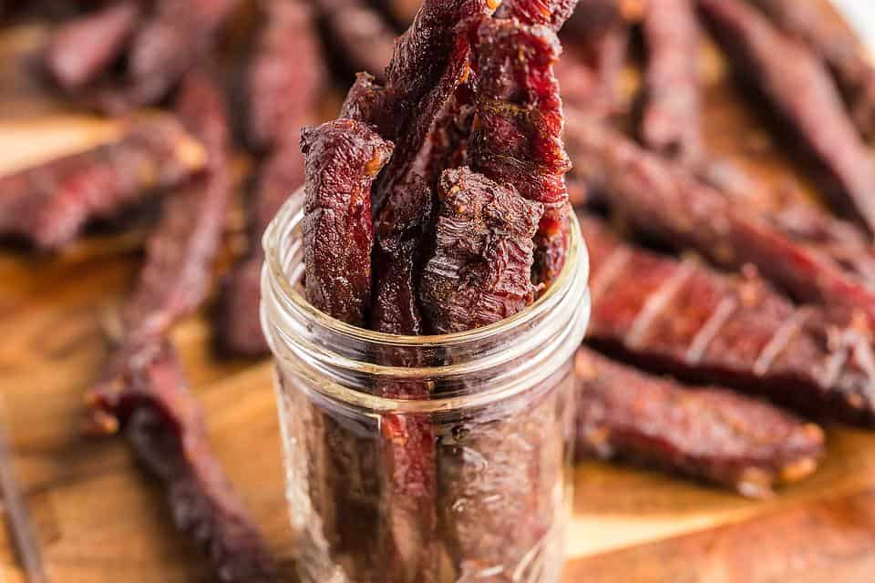 Homemade smoked beef jerky in a jar.