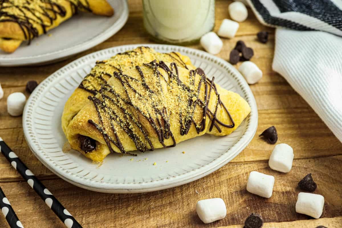 S'mores Crescent Rolls on a plate with marshmallows around.
