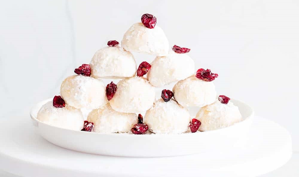 Air fryer Snowball Cookies stacked in a pyramid.