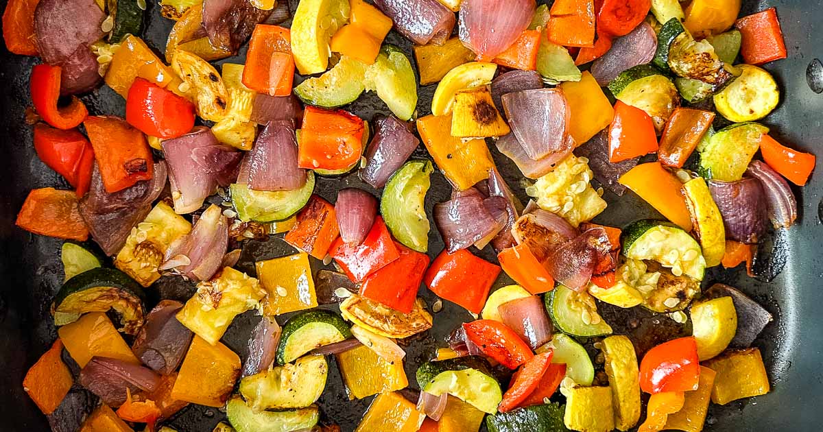 Roasted vegetables in a roasting pan.