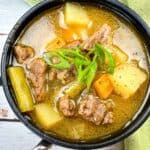 Steak & Potato Soup in a black bowl.