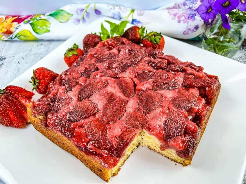 Strawberry Upside Down Cake with a slice missing.