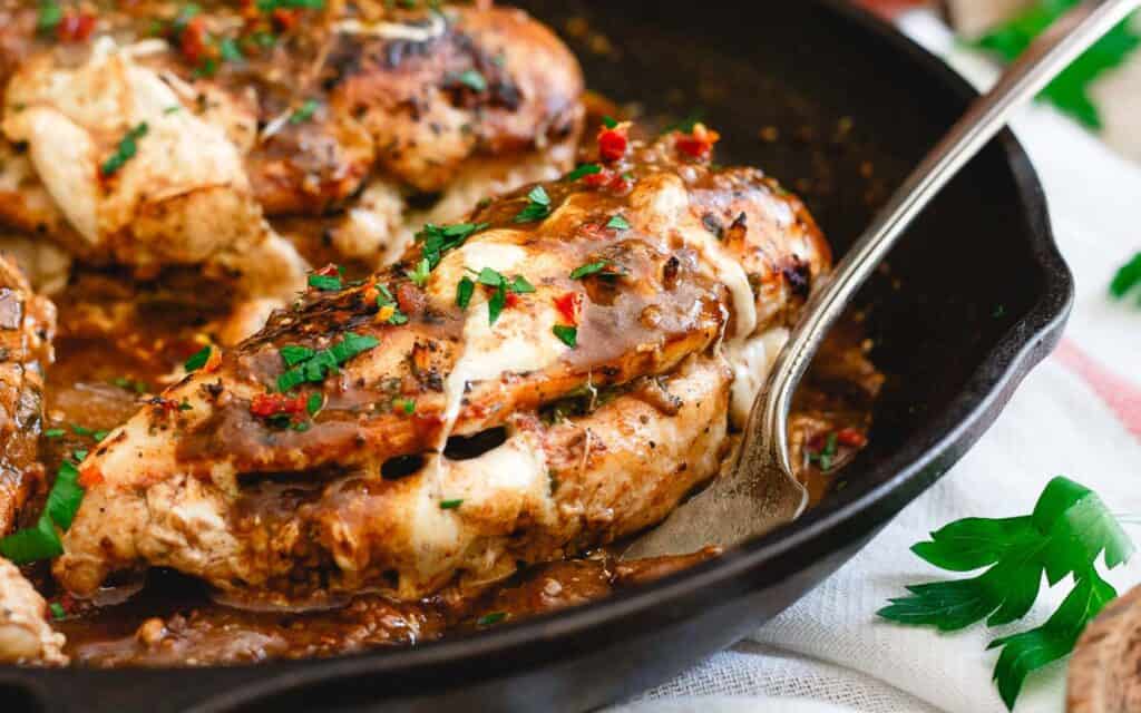 Stuffed chicken marsala in a cast iron skillet.