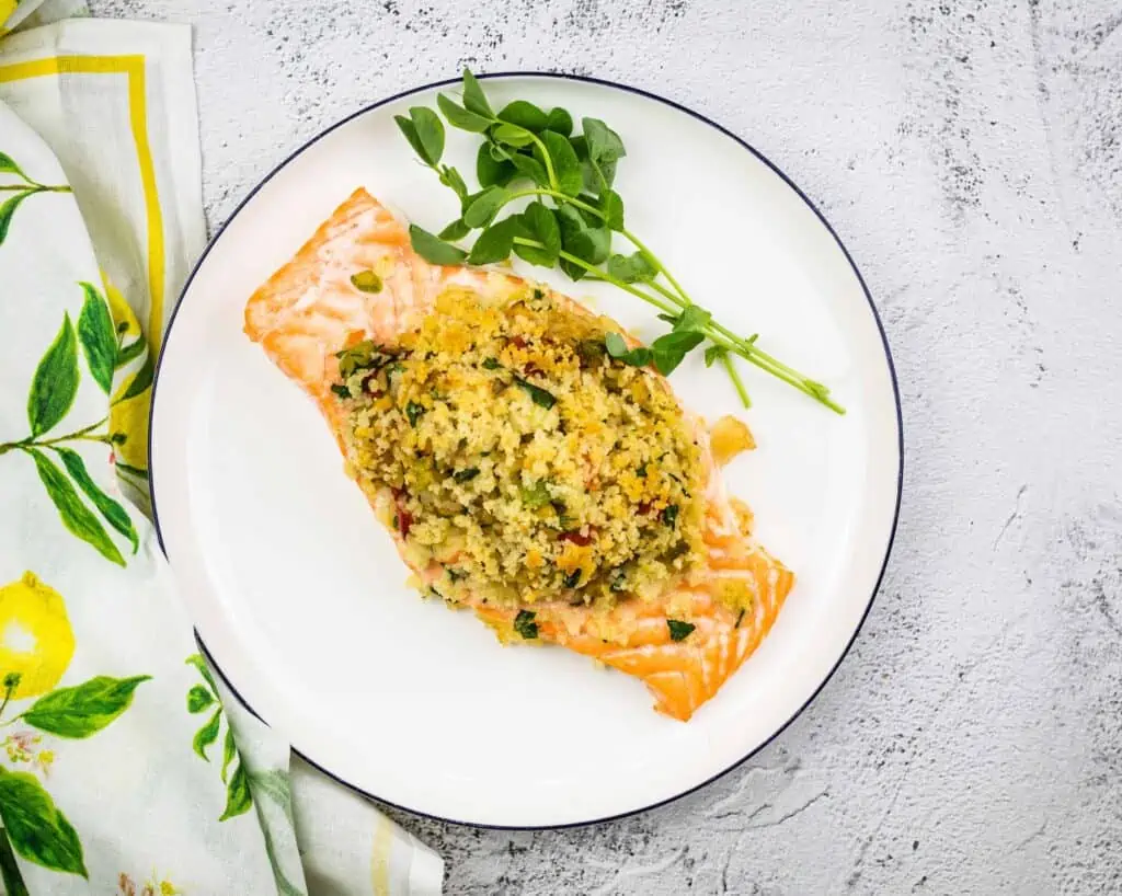 Seafood stuffed salmon on plate.