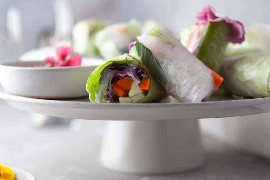 Rice paper rolls filled with veggies and flowers.