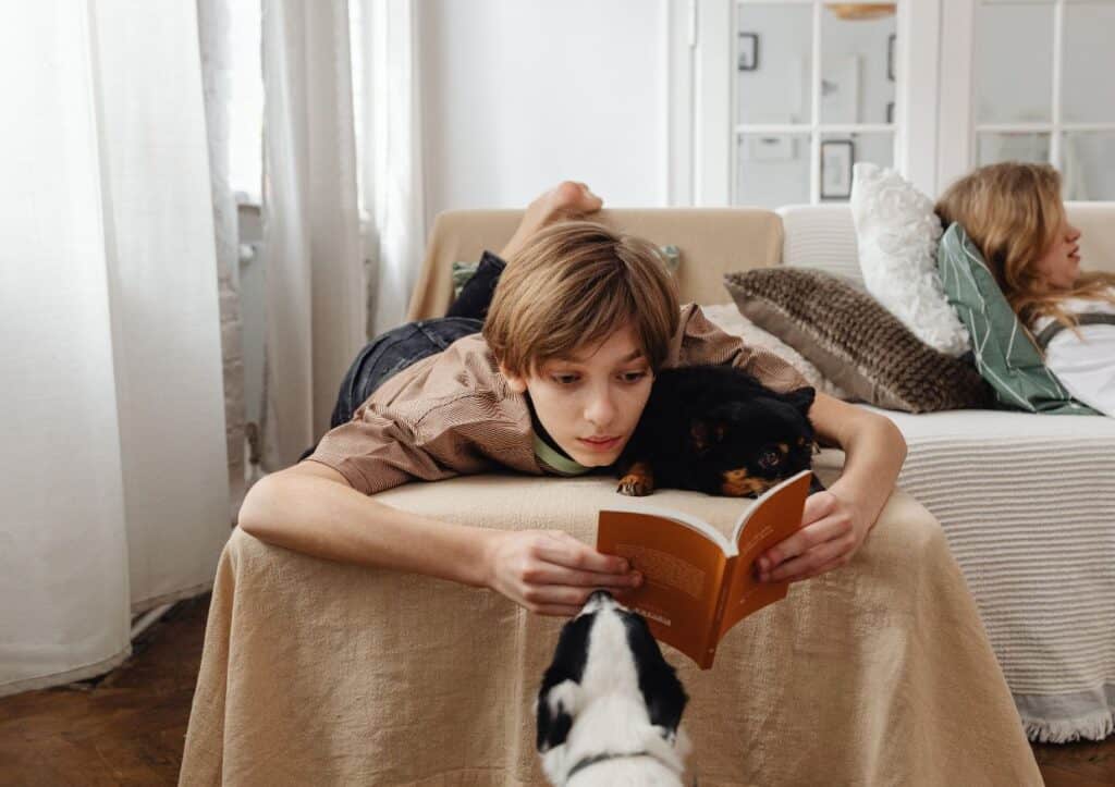 Teen boy reading a book.