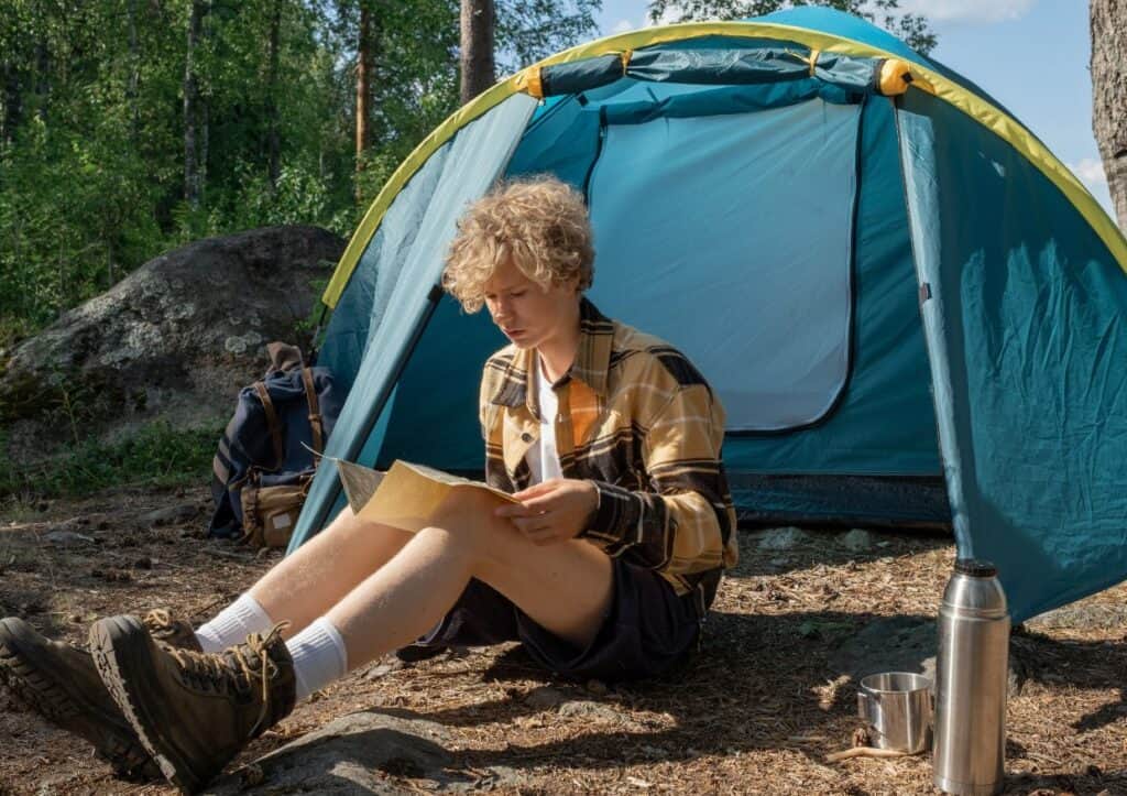 Teenage boy camping.