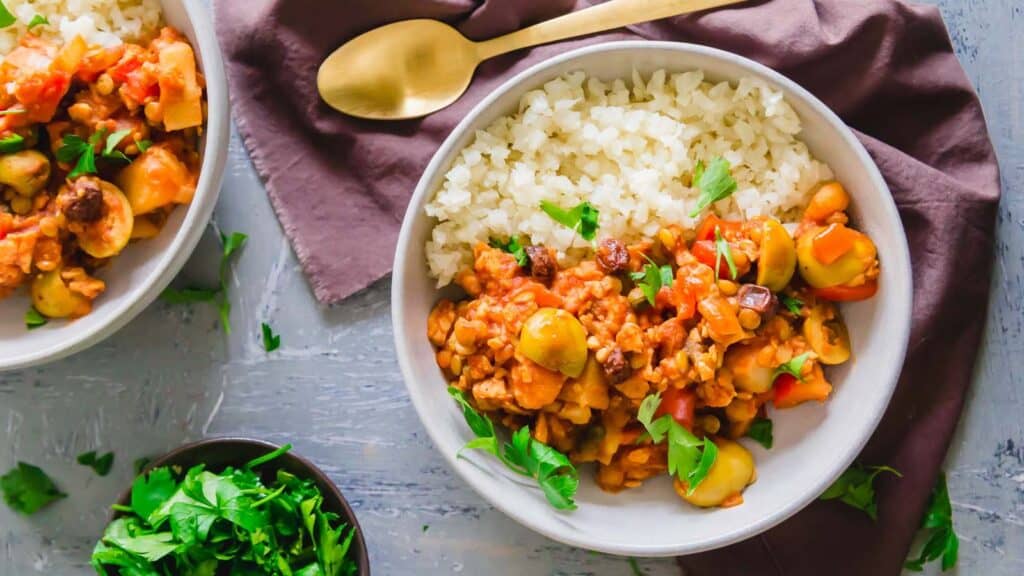 Vegan tempeh picadillo served in a bowl with cauliflower rice.