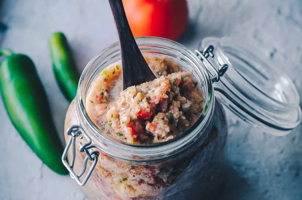 easy fresh salsa in a glass container with a lid.
