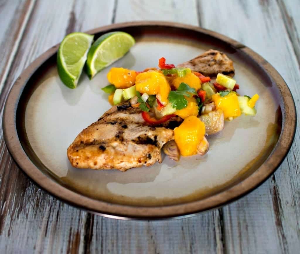 Turkey cutlets with mango relish on a plate.