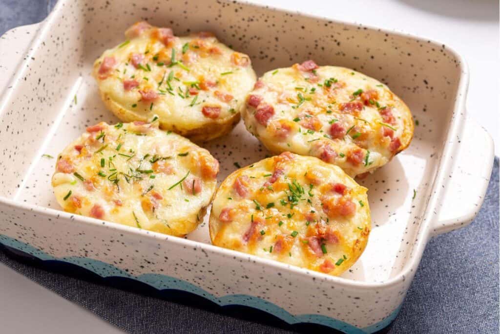 Four twice baked potatoes in a small baking dish.