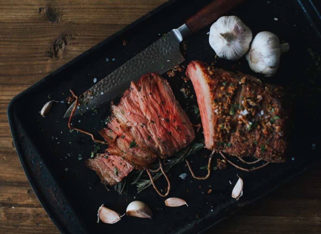 Grilled roast beef, sliced for serving.